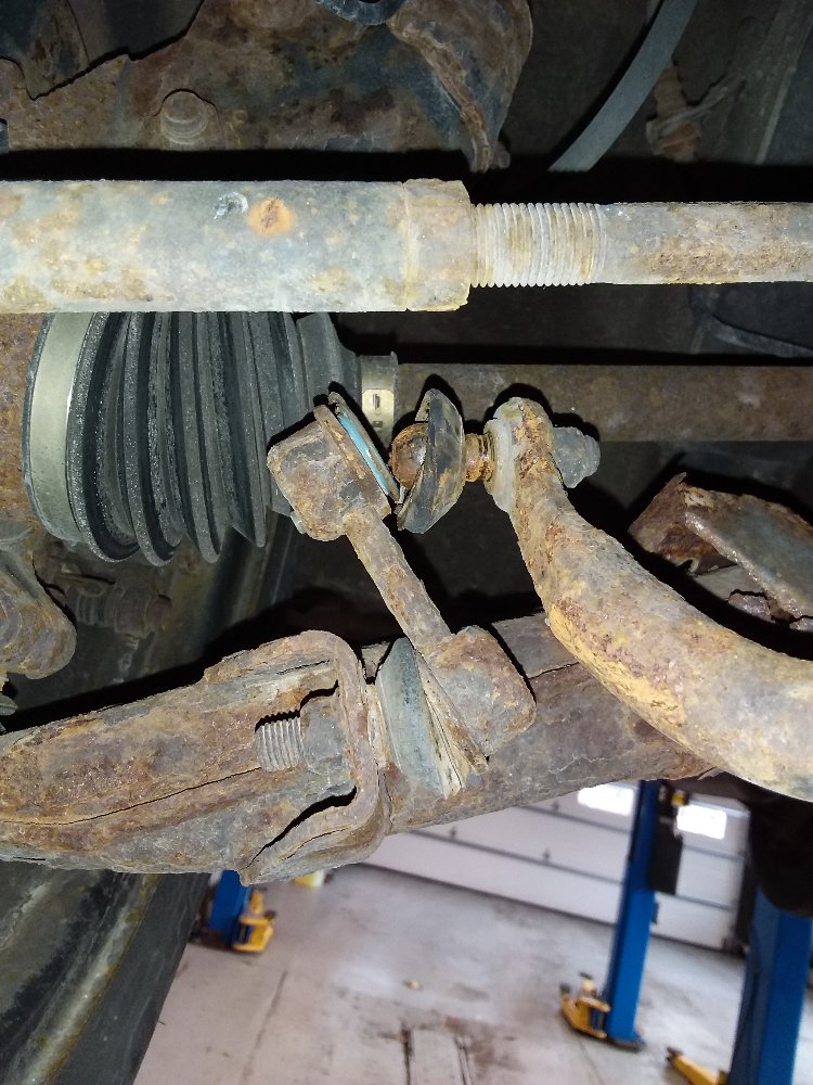 Broken Subaru Forester sway bar link caused by failure of control arm due to rust.