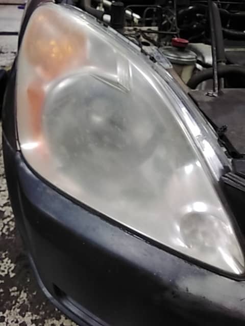 Headlight before refinishing restoration service in Ann Arbor, MI