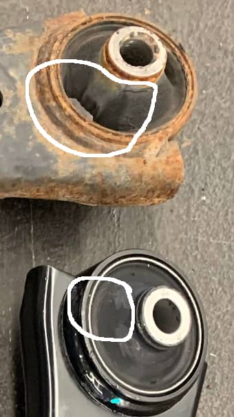 Closeup photo of new and worn Subaru Legacy control arm bushings