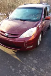 2008 Toyota Sienna with broken front spring and damaged strut.