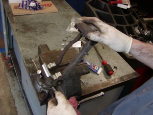 Cleaning and inspecting brake caliper mounting hardware